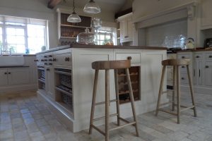 Bespoke country farmhouse kitchen island with in-built wine rack and handmade stools